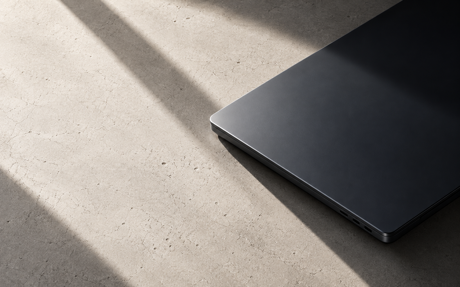 Graphite laptop resting in warm architectural light